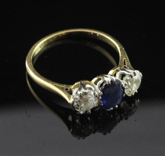 An 18ct gold and platinum three stone sapphire and diamond ring, size 0 and a half.